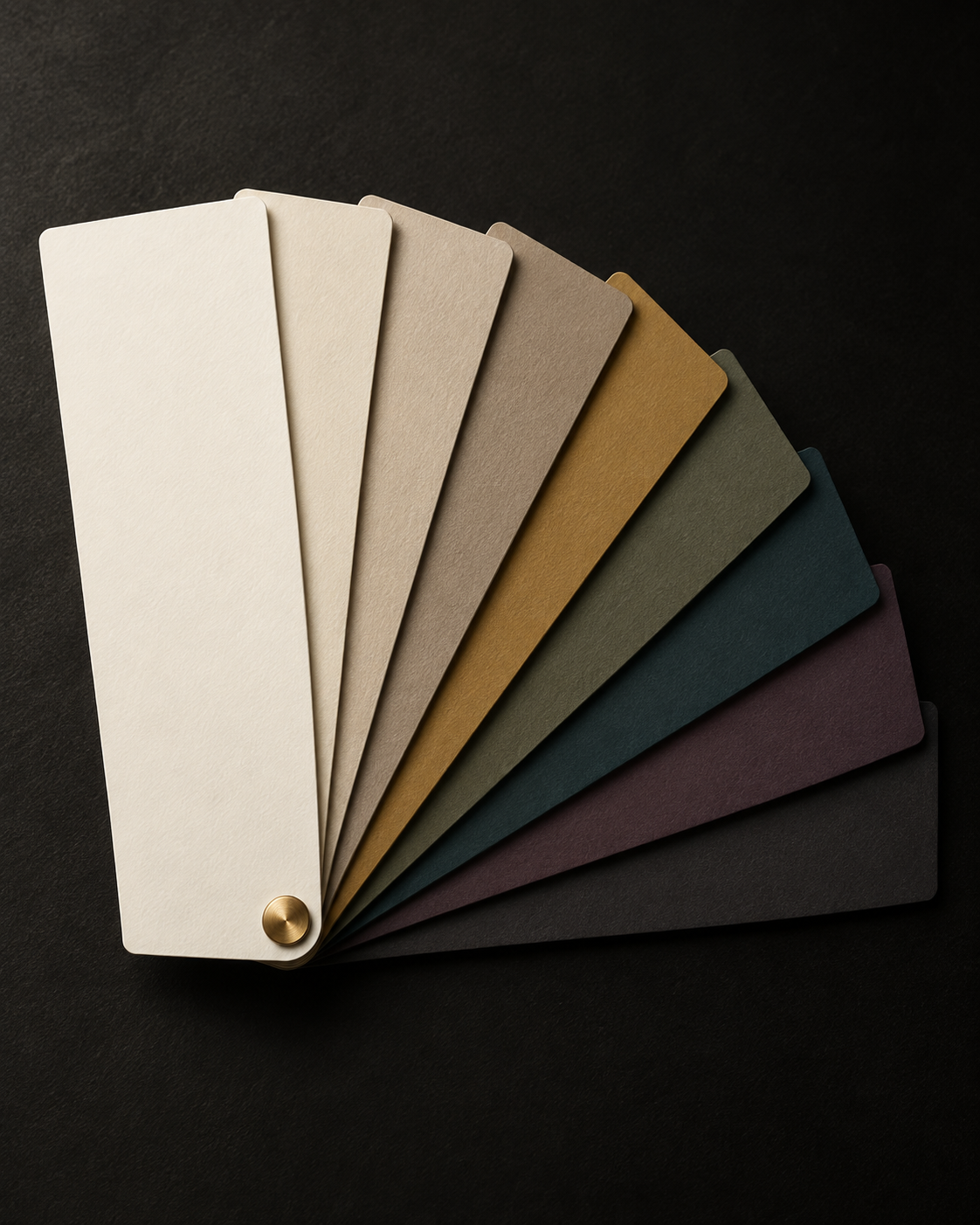 A fan of elegant paint colour samples on a dark background, with a small gold detail